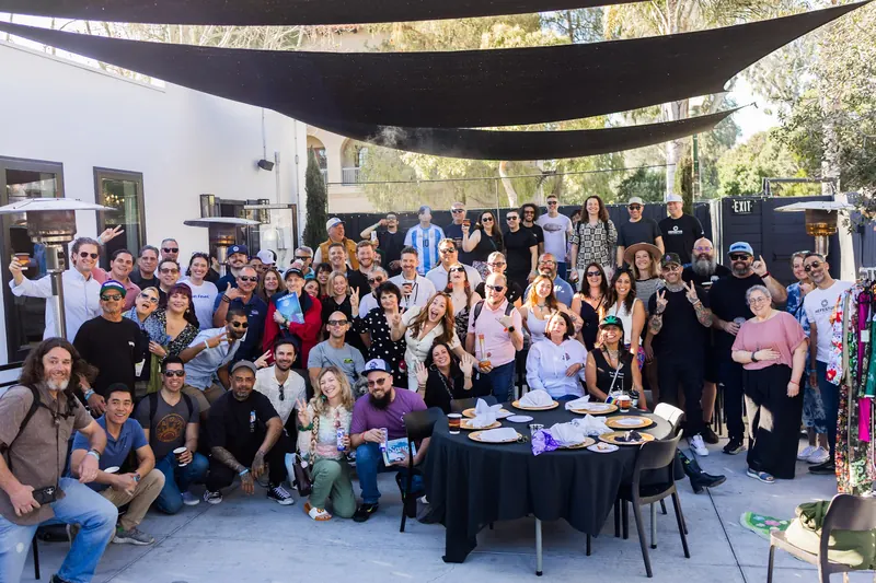 Group photo of the Hall of Flowers Bagel Bash crowd at White House Beach Club in Ventura