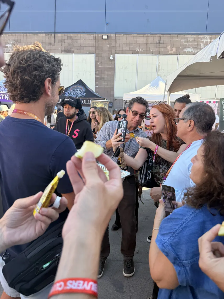 Hands reaching for honey packets and apple slices