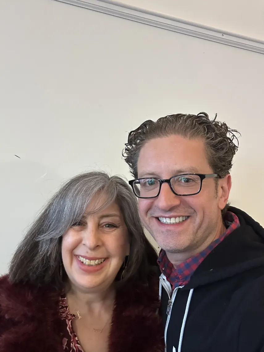 Jordan Isenstadt with a guest in a burgundy coat