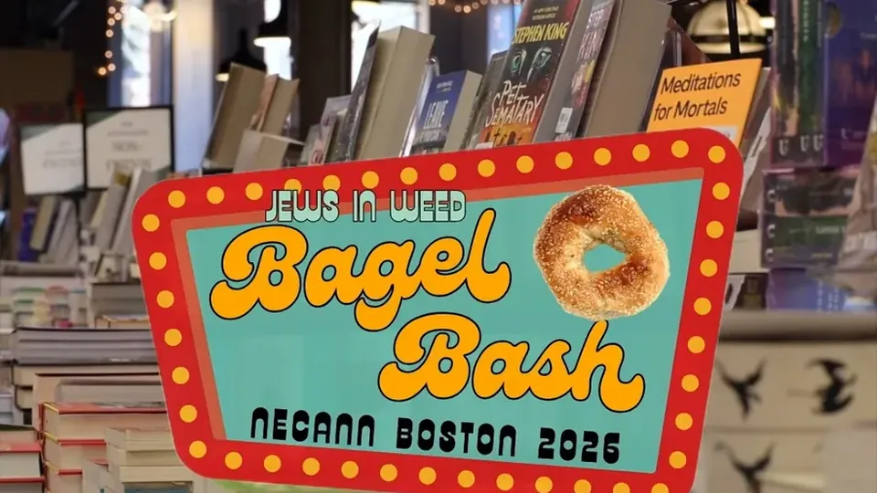 Bagel Bash NECANN Boston 2026 sign over the book displays at Trident Booksellers