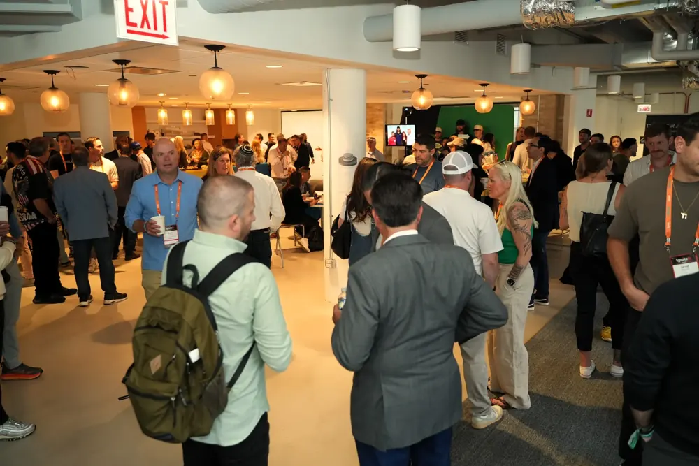 A packed room of attendees mingling at the IgniteIt Chicago Bagel Bash