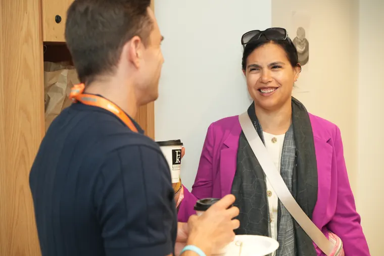 Two attendees talking over coffee