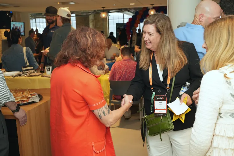 Attendees chatting near the breakfast buffet