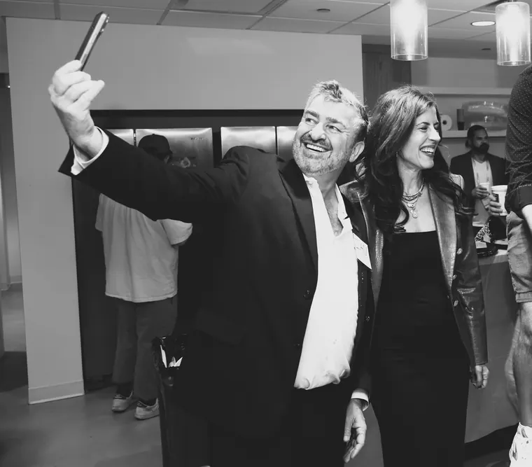 Black and white shot of a guest leading a cheer