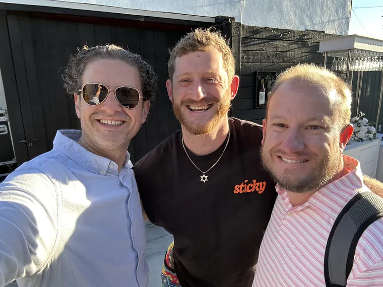 Jordan Isenstadt taking a selfie with two guests on the patio