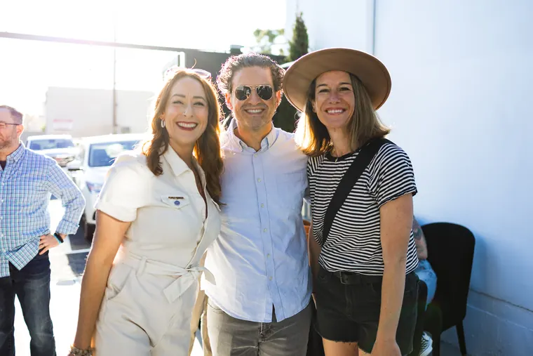 Three friends posing for a photo, one in a wide-brim hat