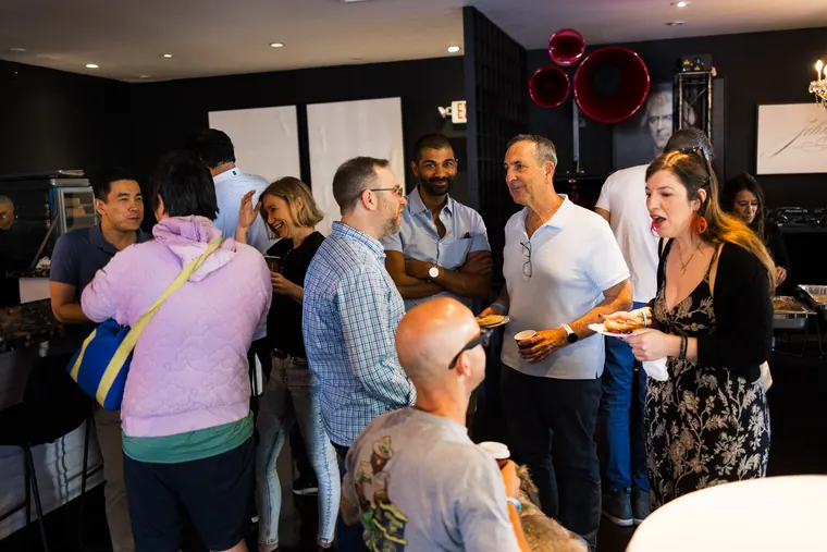Indoor crowd mingling in the clubhouse lounge