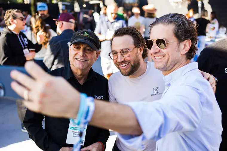 Three guests leaning in for a selfie at the Ventura Bagel Bash