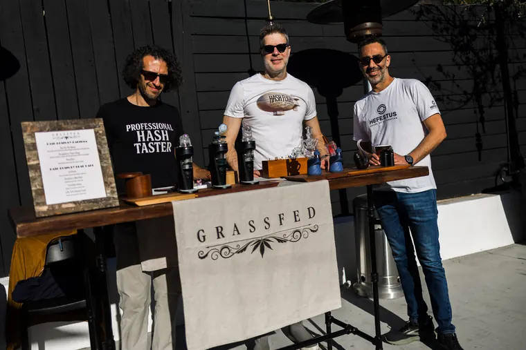 Exhibitors standing behind the Grassfed table