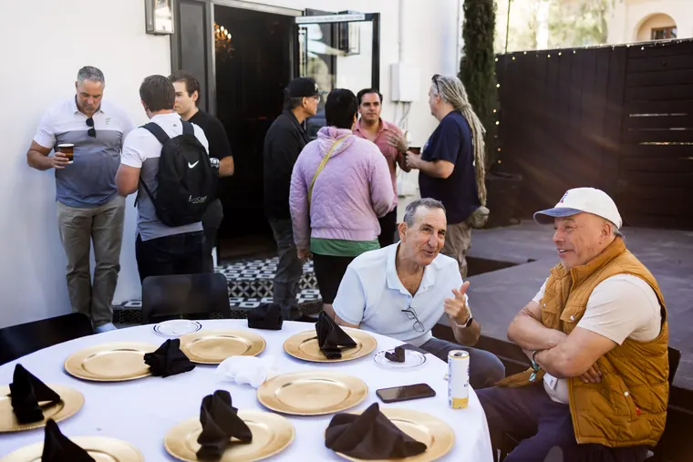 Guests seated at a round table set with gold chargers