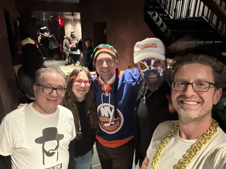 A group in costume at Torches NYC, including a guest in an Islanders jersey and face paint