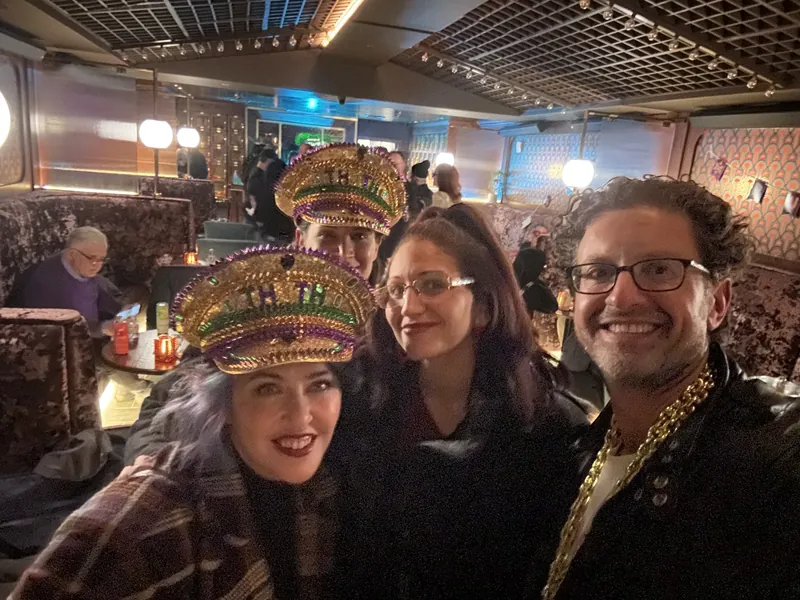Guests in gold captain's hats with Jordan Isenstadt at the Purim party