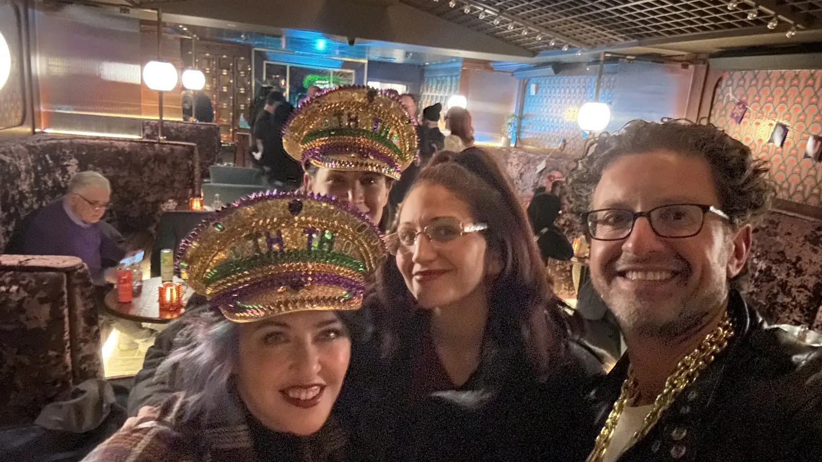 Guests in gold captain's hats with Jordan Isenstadt at the Jews in Weed Purim party